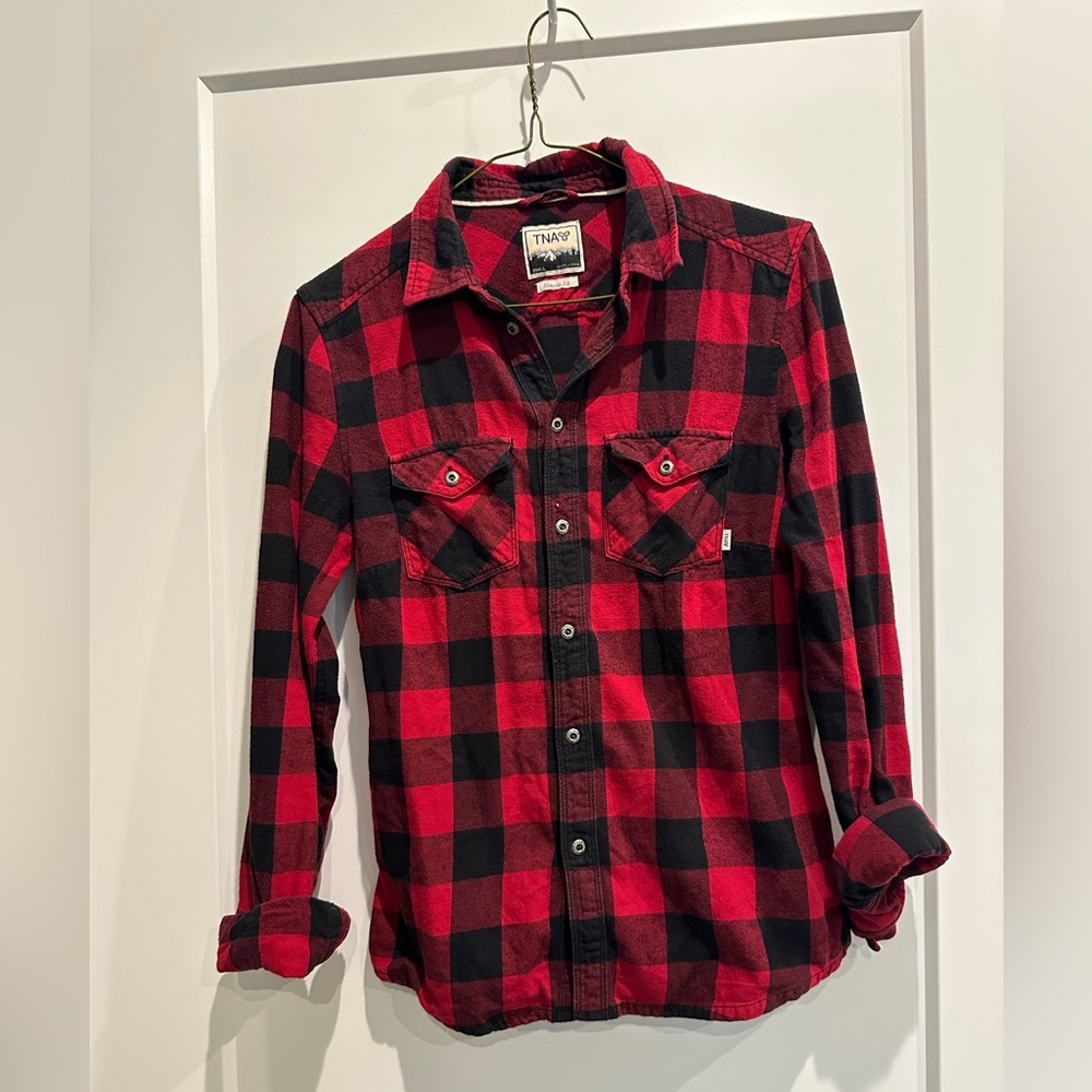 TNA red and black, play shirt. Size small. Worn but well taken care of.